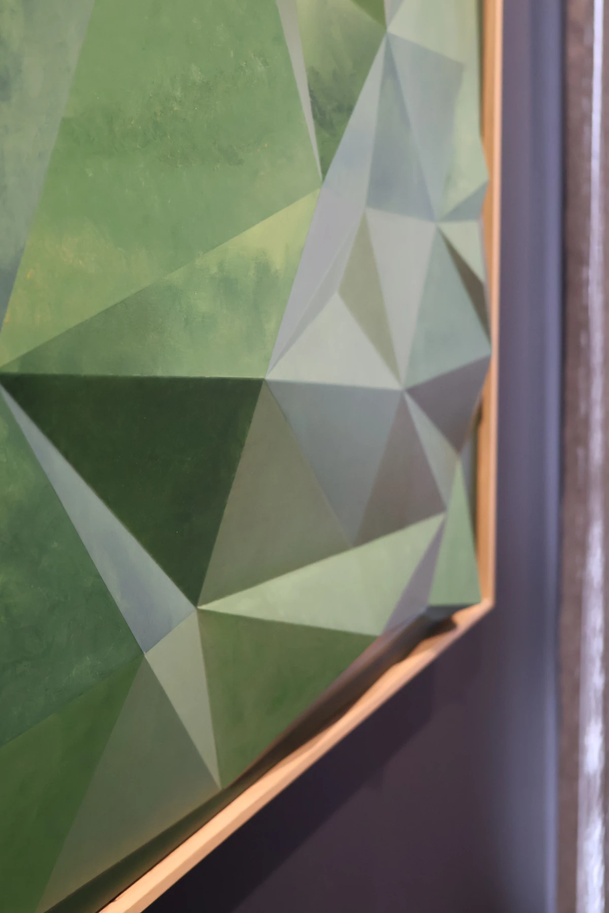 Detail of the green relief and natural timber frame