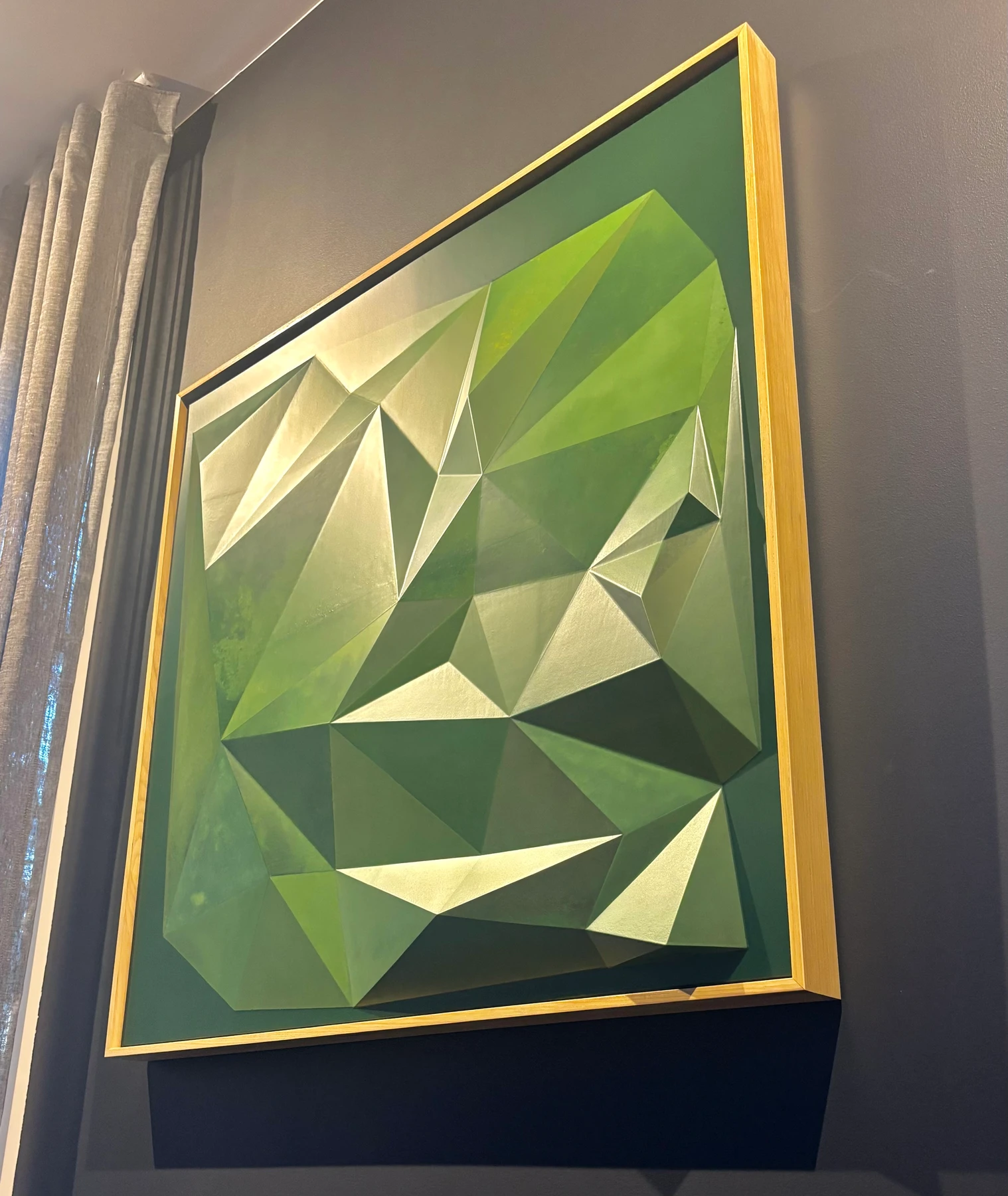 Angled view of the green geometric relief