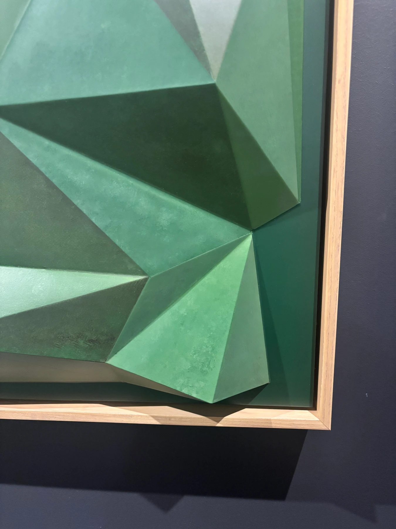 Close-up of green painted facets and the timber frame