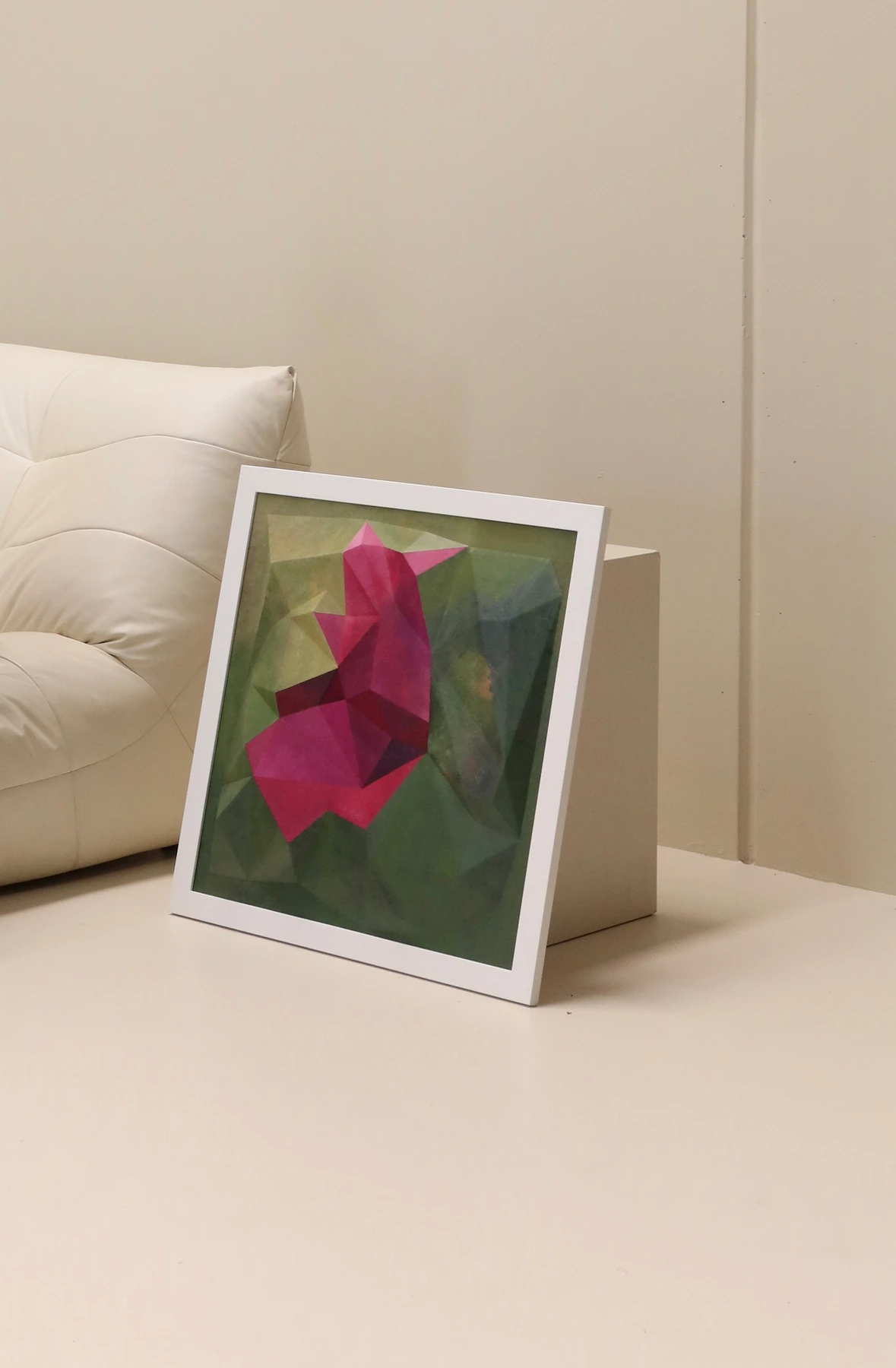 Angled view of Still Becoming beside a white sofa